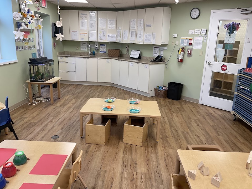 Toddler classroom kitchenette with sink, counter, and cabinets used for feeding prep