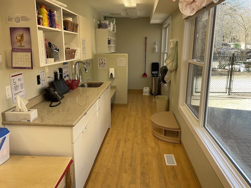 Staff kitchenette with overhead cabinets, sink counter, and phone