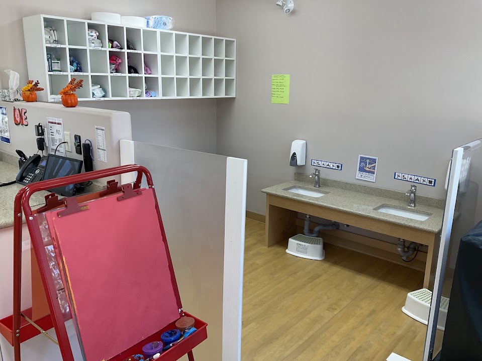 Art easel beside a child-height double sink